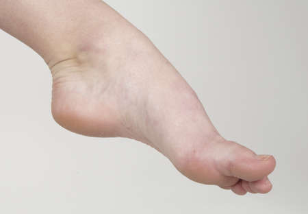 Close up of woman s bare feet against a white studio background