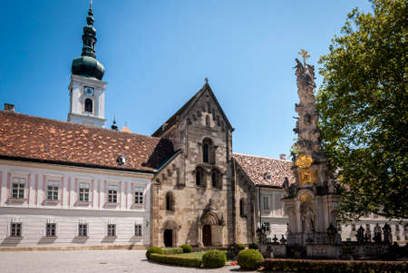 HEILIGENKREUZ, VIENNA, AUSTRIA - AUG 9 , 2019: inner Yard and View of the Cistercian monastery Heiligenkreuz (holy cross) abbey with trinity columnのeditorial素材