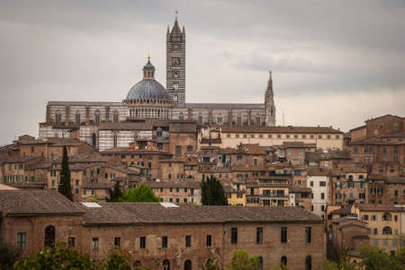 Scenery of Siena, a beautiful medieval town in Tuscany, with view of the Dome & Bell Tower of Siena Cathedral (Duomo di Siena)の写真素材