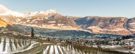 Beautiful view on the alpin city of Meran (Merano) and the Village of Lagundo (Algund) and Foresta (Forst) in SÃ¼dtirol, Alto Adige, Italy under the snow in winterの写真素材