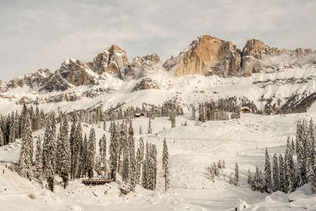 The Rosengarten-Schlern group (Gruppo Catinaccio Sciliar) and the village of Karersee or Carezza in the Dolomites in Italian Alps, SÃ¼dtirol, Alto Adige in winter with snowの写真素材