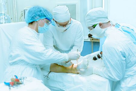 Group of doctors doing the actual operation in the traumatology departmentの写真素材