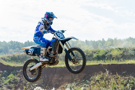 The young sportsman on a motorcycle jumpの写真素材