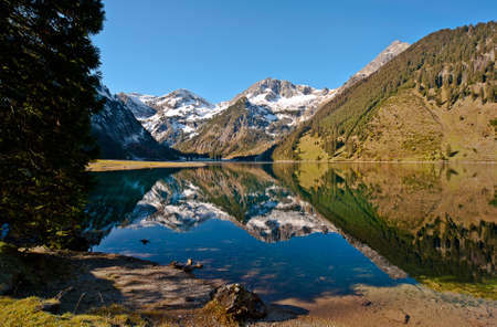 The Vilsalpsee in October with the ball Horn, roughness as a reflection in the lakeの写真素材