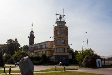 Administration of the City of Gdansk. The inscription on the facade is translated as "Captain of the Port". In the background there is a historic building of the lighthouse. Polandのeditorial素材