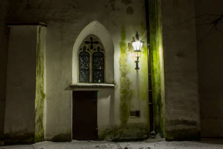 The door and window on the historic wall of Cathedral of Saint Mary the Virgin in Tallinn at night. Estoniaの写真素材