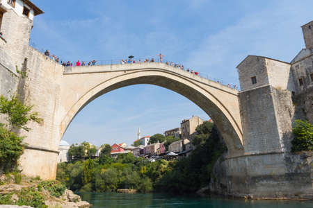 A young man jumps from the historic Old Bridge in Mostar. Bosnia and Herzegovina. 20 september 2018のeditorial素材