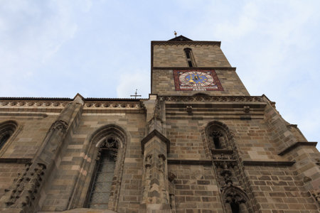 View of the bell tower of the historic gothic Black Church in the city of Brasov. Transylvania....