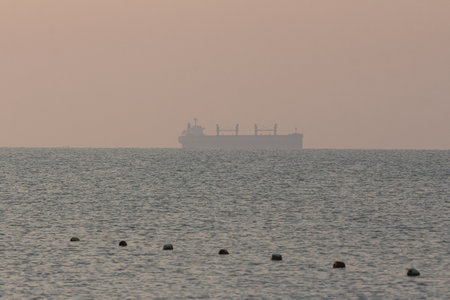 Silhouette of a sea tanker in the sea at dawn. Odesa. Ukraineの写真素材