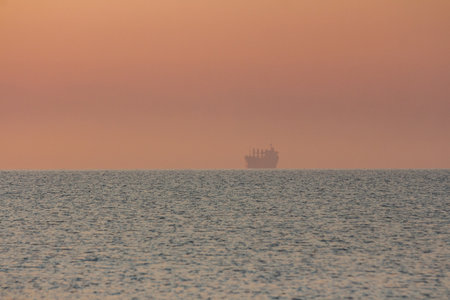 Silhouette of a sea tanker in the sea at dawn. Odesa. Ukraine