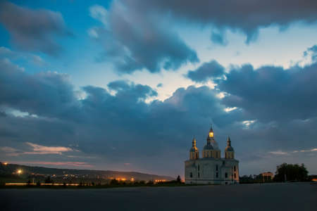 The lights of the church and town in the dusk