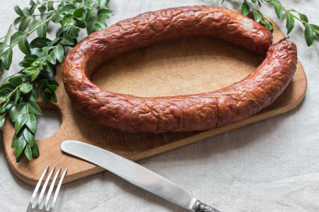 Smoked tasty homemade sausage on a chopping board
