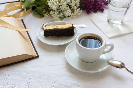 Morning coffee with cheesecake while reading a bookの写真素材