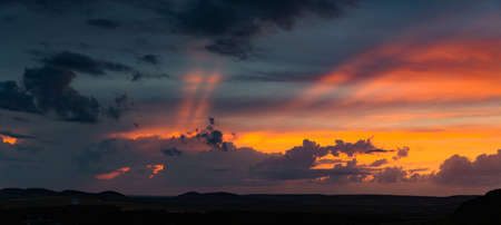 Huge beautiful cloudscape in evening. Red sun just gone awayの写真素材