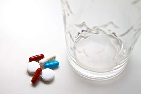 Water glass with pillsの写真素材