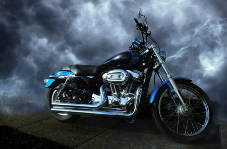 Riderless motorcycle  Clean, shiny, sparkling paint and chrome  Dynamic storm cloud background の写真素材