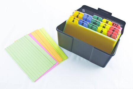  Black plastic alphabetized filing box with several colored index cards laid out  の写真素材