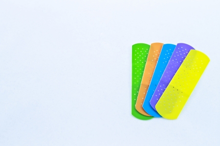 Five different colored children’s adhesive bandages 