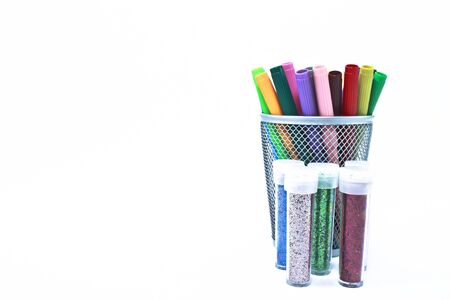 Metal container with a multitude of colored markers propped inside, including every shade of the...