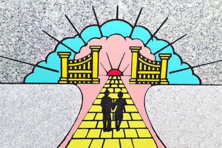 Colored marble engraving of a couple headed toward the gates of heaven.の写真素材