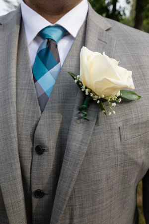 Midsection of man wearing suit with boutonniereの写真素材
