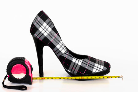 A plaid high heel is being measured.の写真素材