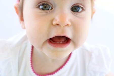 Baby turns one and has two bottom teeth.の写真素材