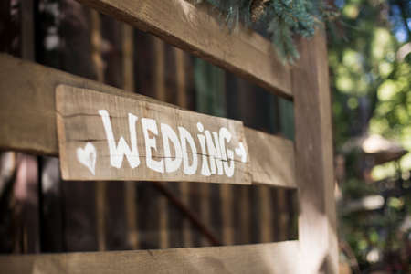 The word wedding is painted a sign with a directional arrow.の写真素材