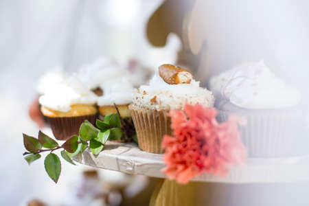 A wedding cupcake is topped with a pretzel.の写真素材