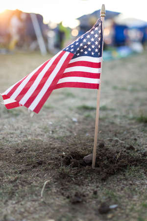 An American flag waves proudly during a sunset in fresh soil.の写真素材
