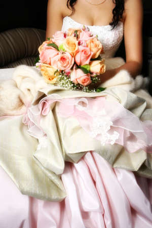 Composition on a wedding theme: fiancee with roses at the back seat of a limousineの写真素材