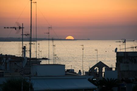 Sunset on the Apulian coast. In the background you can see the Duomo of Traniの写真素材