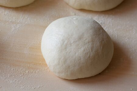 Pizza dough. Isolated pizza ball before cookingの写真素材