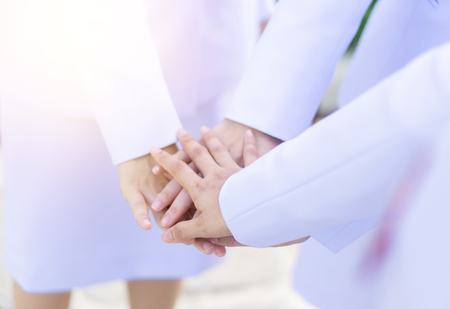 Group of nurse join hands for teamwork,unity,corporate,health care business conceptの写真素材