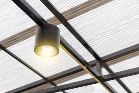 A black ceiling light with warn light in modern houseの写真素材
