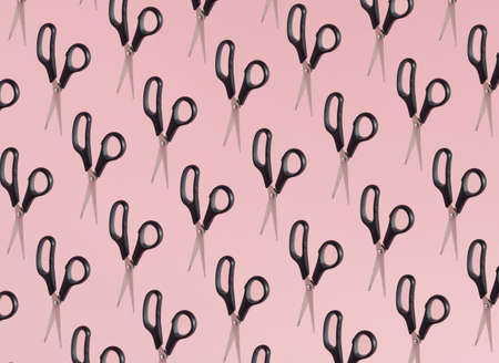 Pattern of black scissors isolated on pink background. Minimal concept.の写真素材