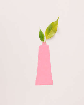 Tube of paint shaped from pink paint and green leaves come out of tube. Minimal creative idea...