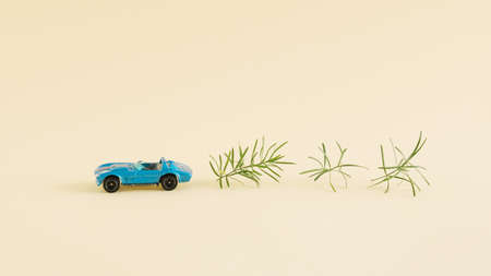 Creative electric car arrangement made of car and green leaves of the plant on the bright background. Minimum renewable energy concept. Environmental non-pollution inspiration.の写真素材