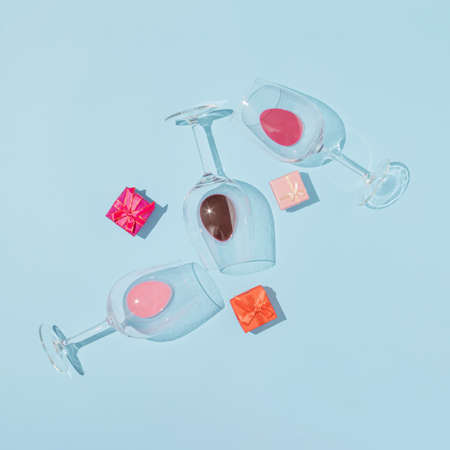 Creative arrangement made of glasses and gifts on a blue background. Celebration and party...