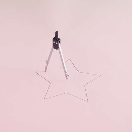 Creative arrangement made of drawn star and divider on a pastel pink background. Minimal geometric concept. Christmas and New Year inspiration.の写真素材