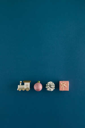 Creative arrangement made of locomotive and New Year's stuff on a blue background. Minimal vertical...