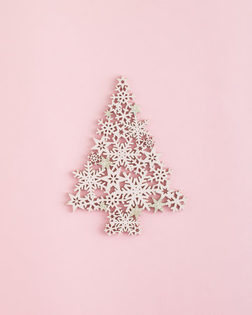Christmas arrangement made of a Christmas tre on a pastel pink background. Minimal New Year concept. Winter inspiration.の写真素材