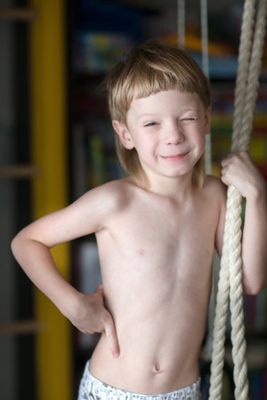 Portrait of beautiful blond boy at home.の写真素材