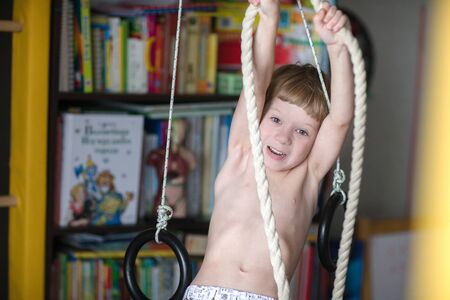 Portrait of beautiful blond boy at home.の写真素材