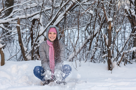 Beautiful young girl walking in winter forest.の写真素材