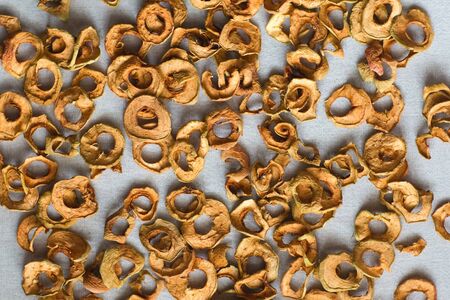 Dried apples sliced lie on linen fabric. Dried fruit compote for cooking.