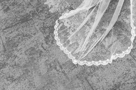 Beautiful white veil lies on the floor. The bride is the wedding ceremony, and her veil stretches.の写真素材