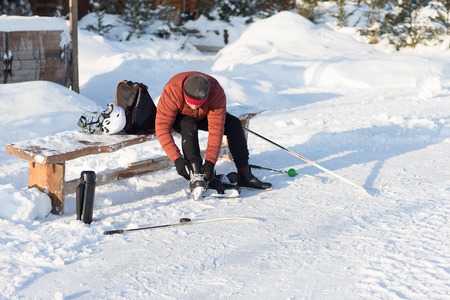 The man wears a winter skates at the rink. Humans disguises shoes on skates.の写真素材