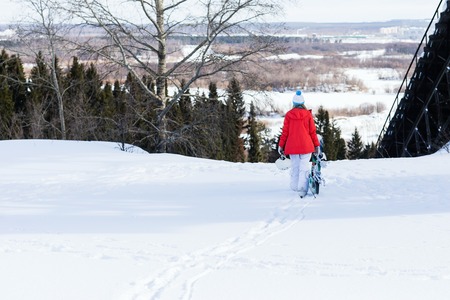 Woman snowboarder on the slopes frosty winter day.の写真素材