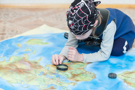 child boy in Pirate costume checking mapの写真素材